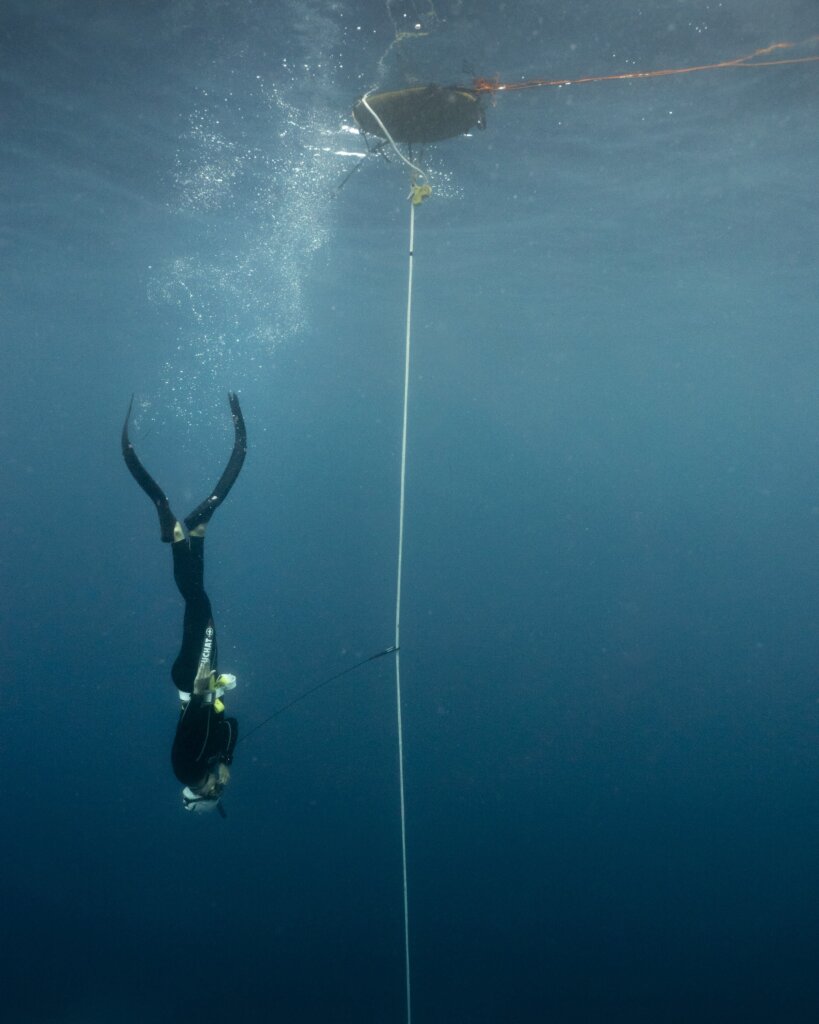 A freediver descending along the line during a training session.